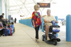 Couple with Husband using Scooter at Cruise Port Terminal